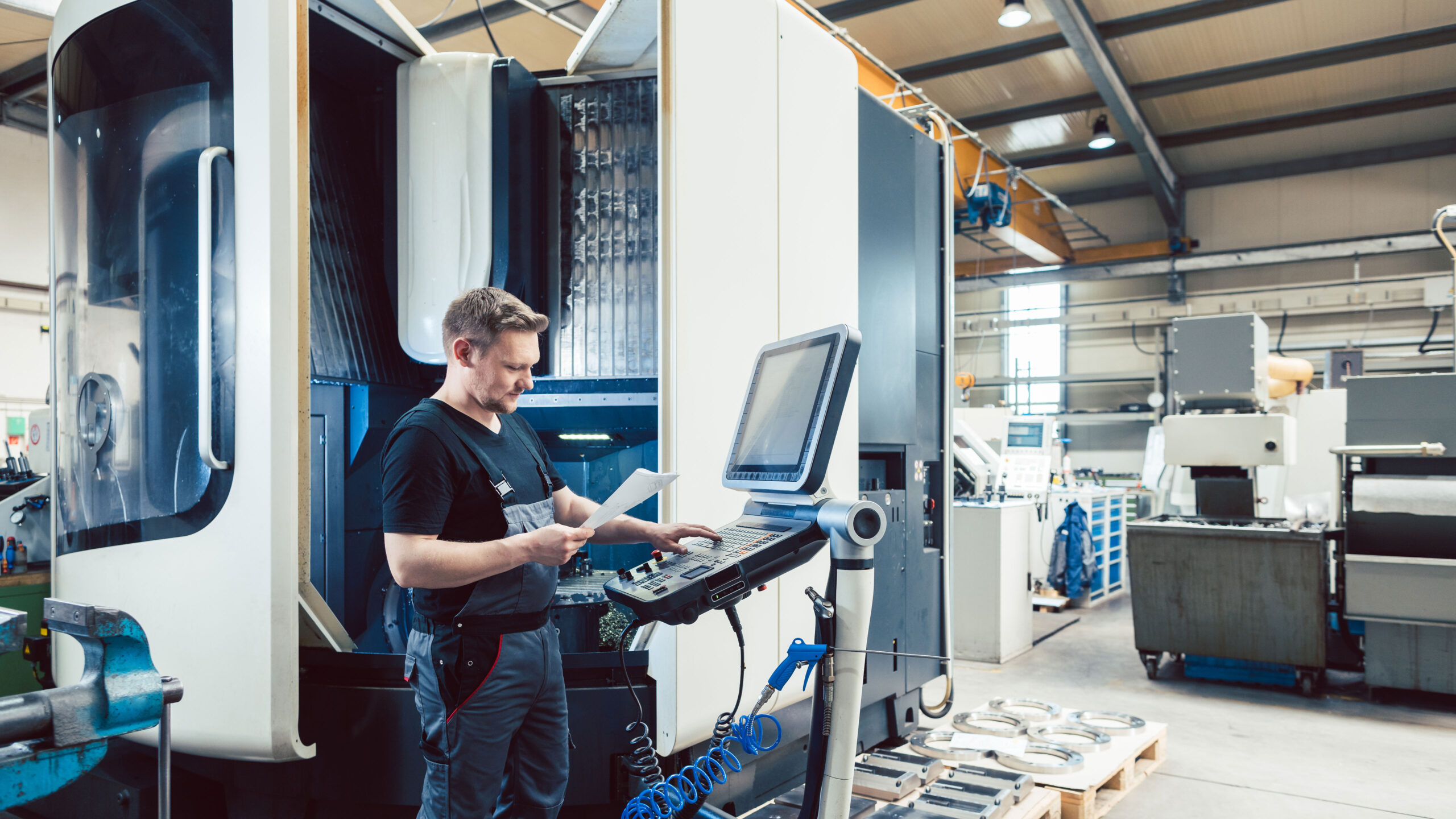 Man looking at paper using a large machine